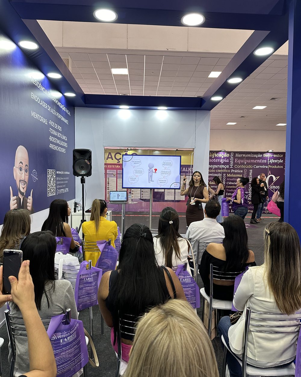Plateia cheia acompanhando a palestra da Kathleen na feira de estética